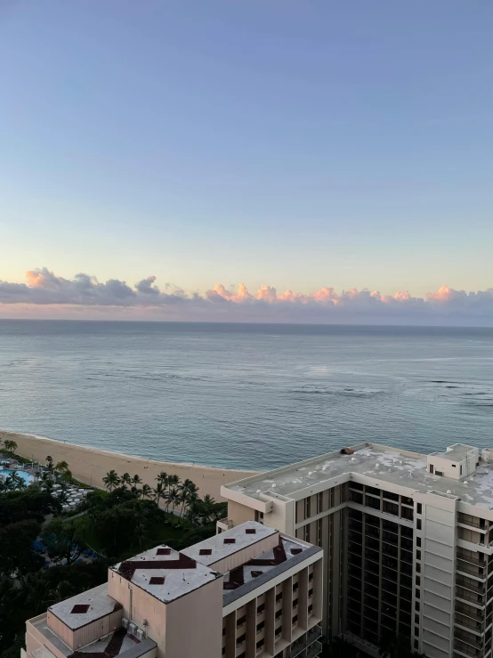 an image of the ocean taken from a balcony at sunset