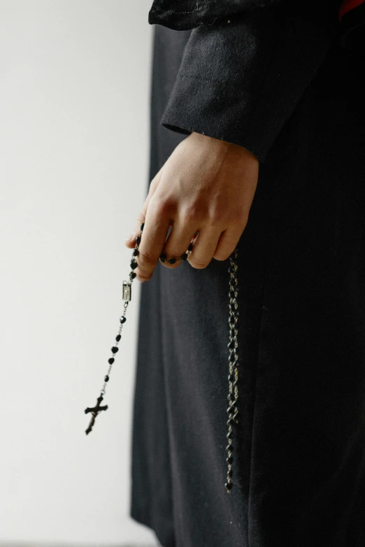 a person with a rosary holding it to their chest