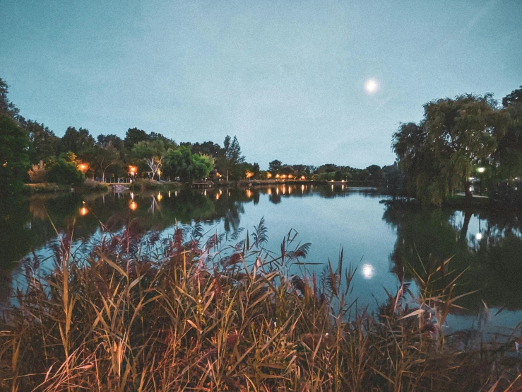 full moon on the night sky above water