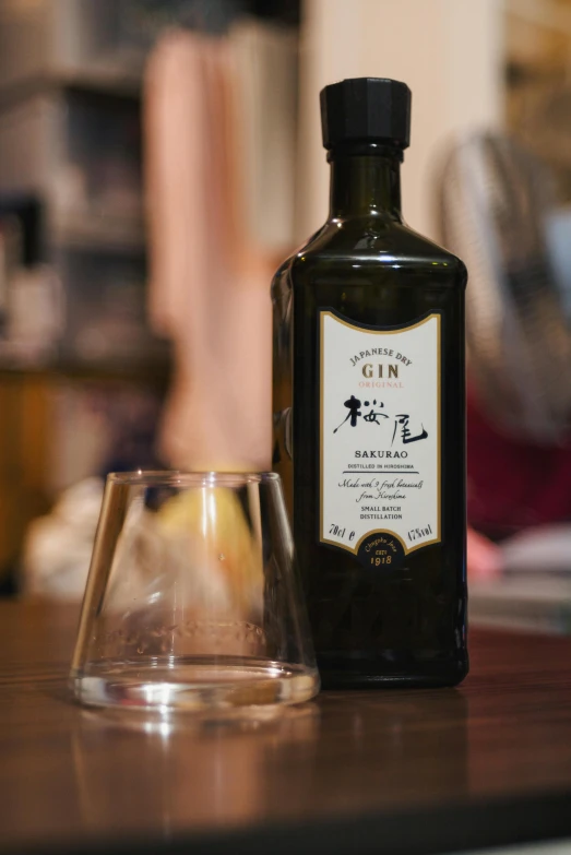 an old fashioned bottle sits next to an empty glass