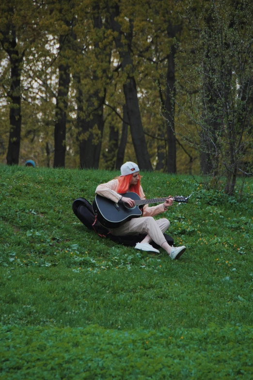 a person in the grass with an instrument