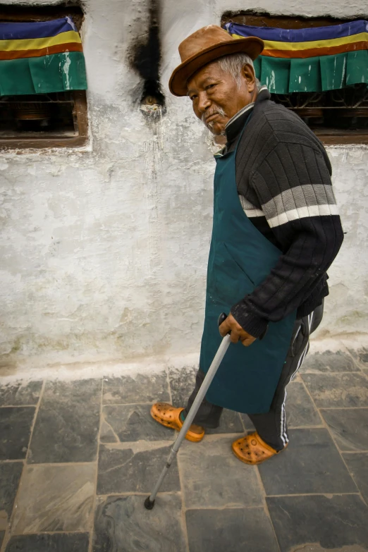 a man is dressed in a blue coat and orange shoes