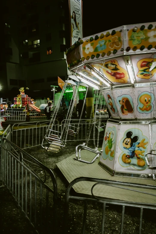 an amut park at night with people riding the rides