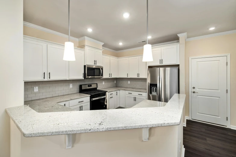 a large kitchen with an island and white cabinets