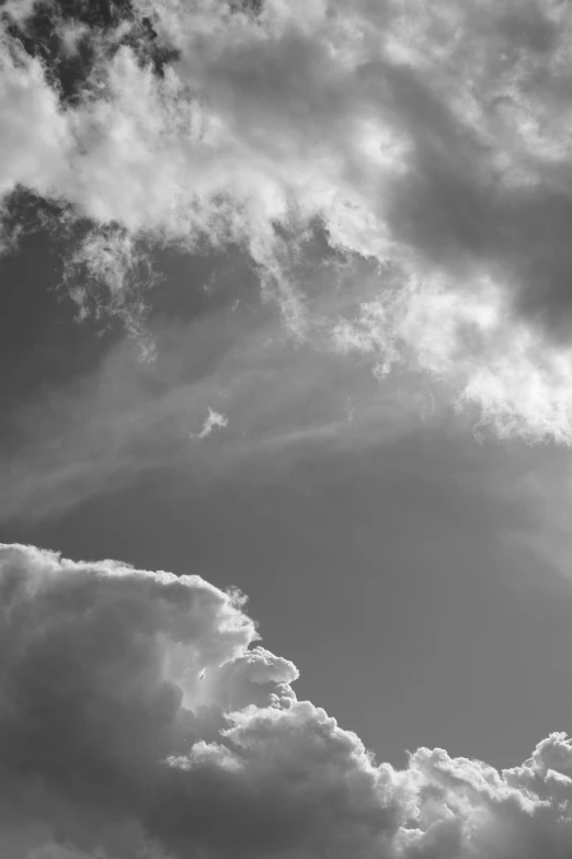 some dark and light clouds in a black and white sky