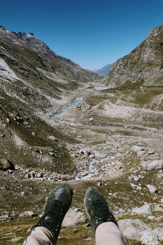 a person wearing hiking shoes overlooking mountains in the distance