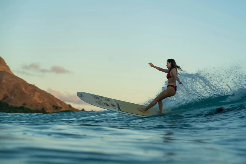 a woman is riding a surfboard in the ocean