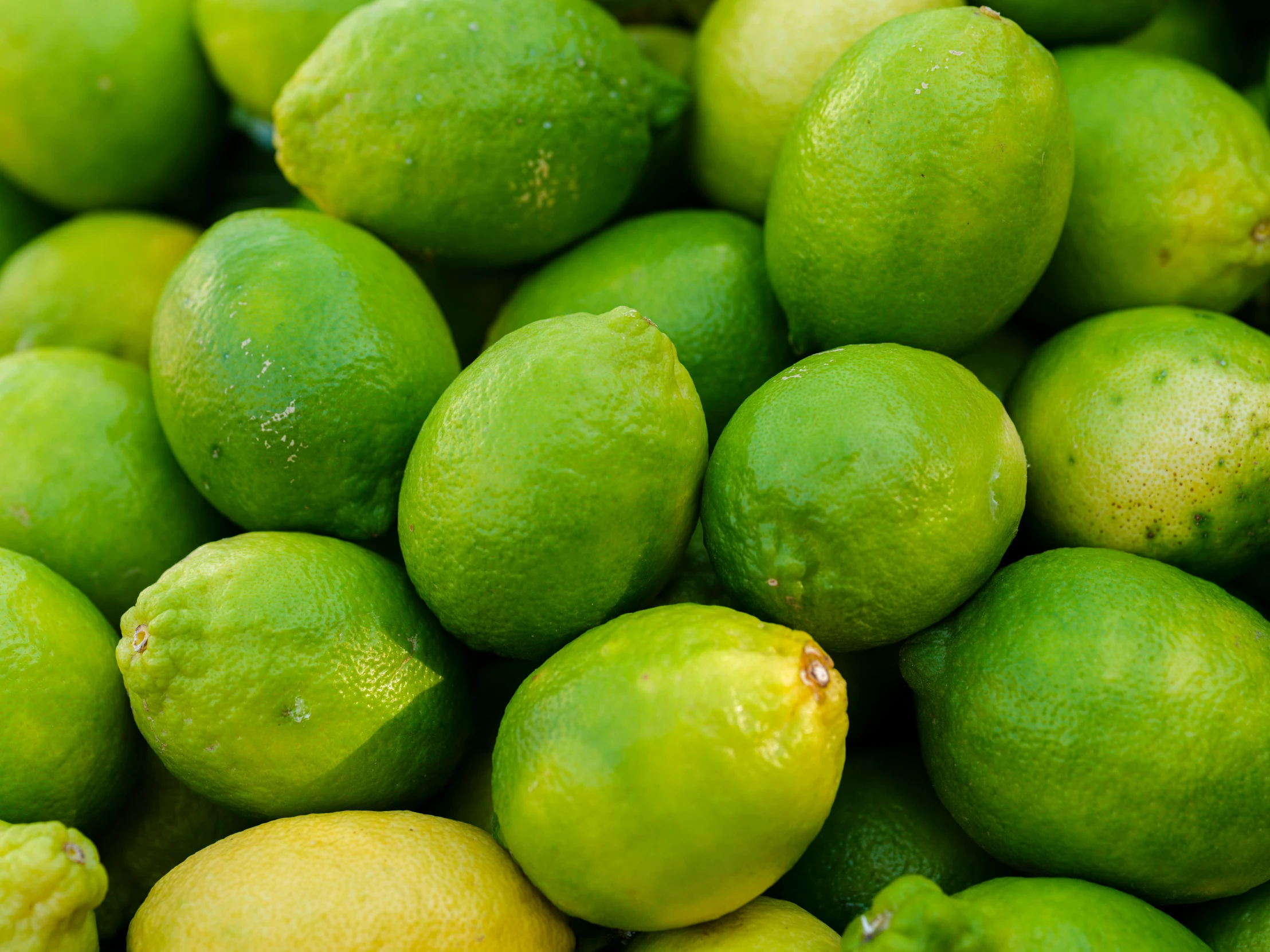 a pile of limes sitting next to each other