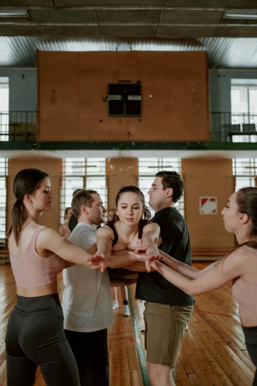 three men and one woman are dancing together