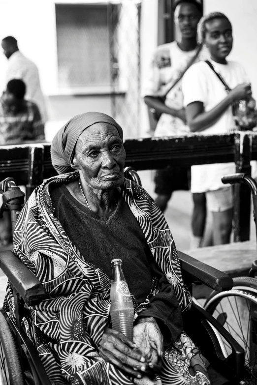 a woman sitting next to a group of people