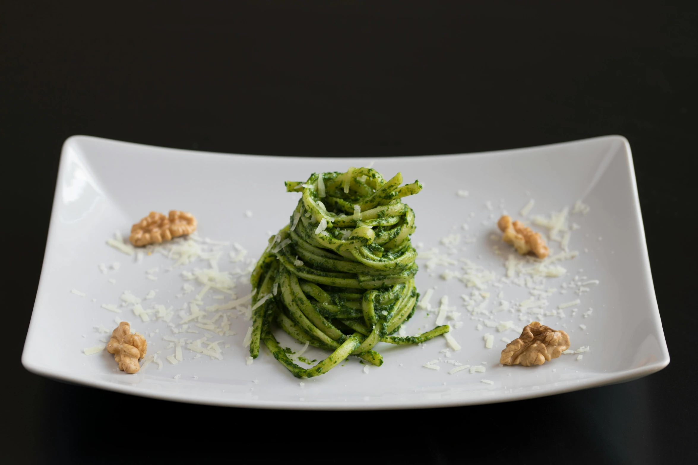 food and garnishes in a plate on a black table