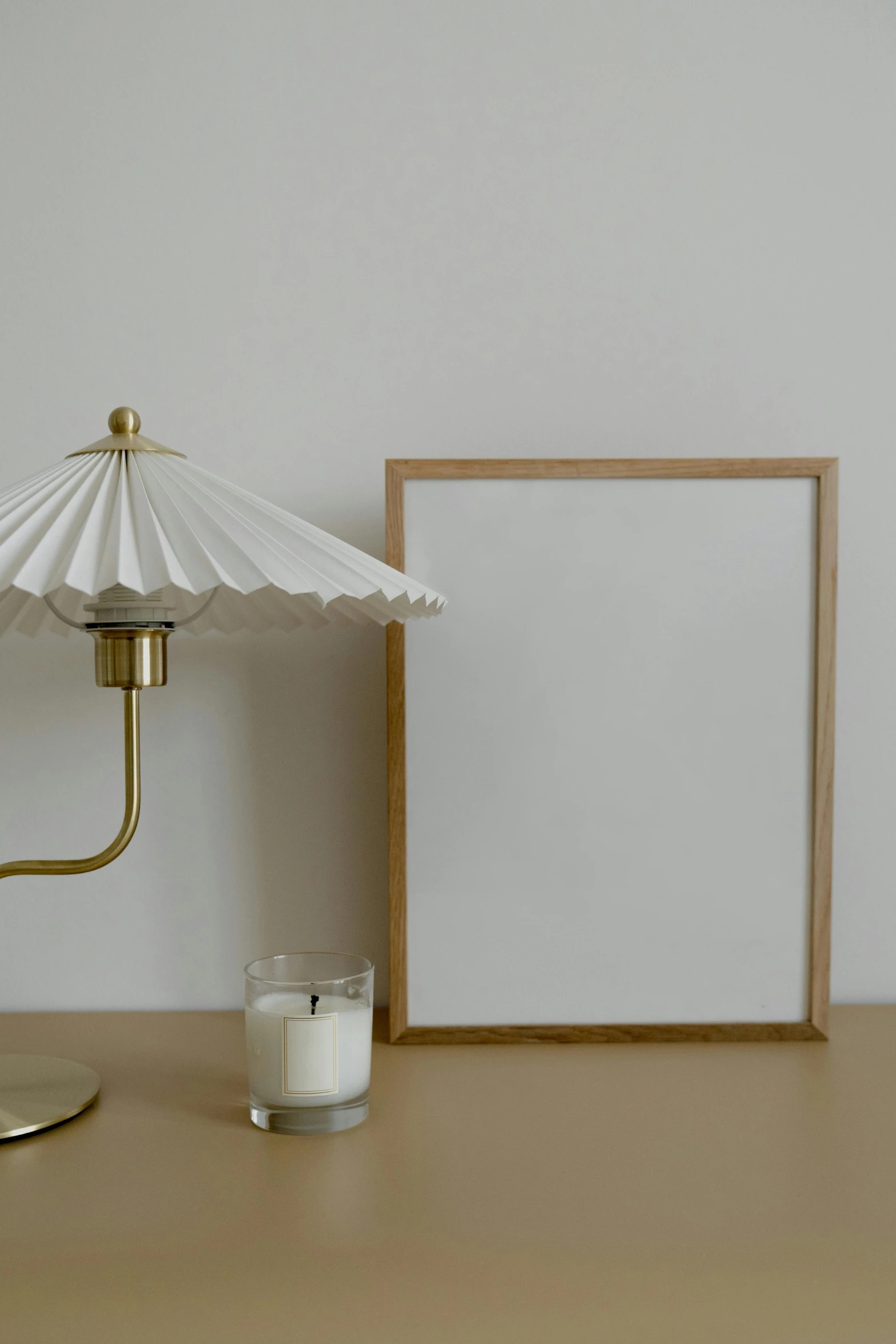 a table with a lamp and candle on it