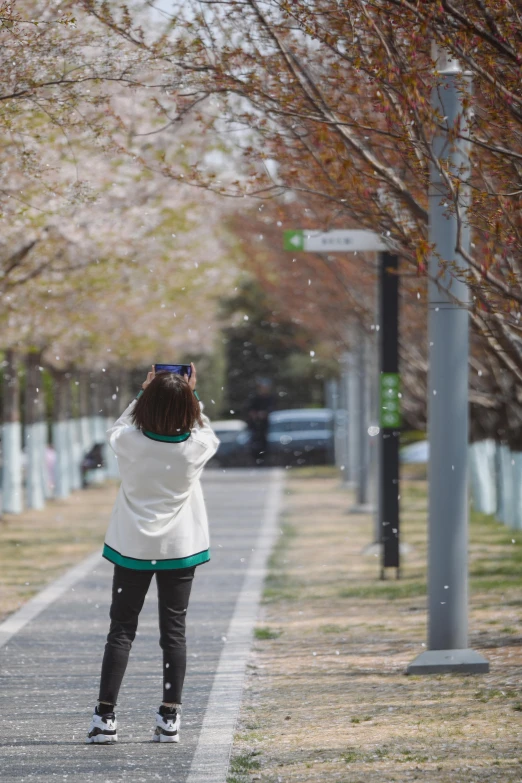 a person is looking up in the sky while holding onto an umbrella