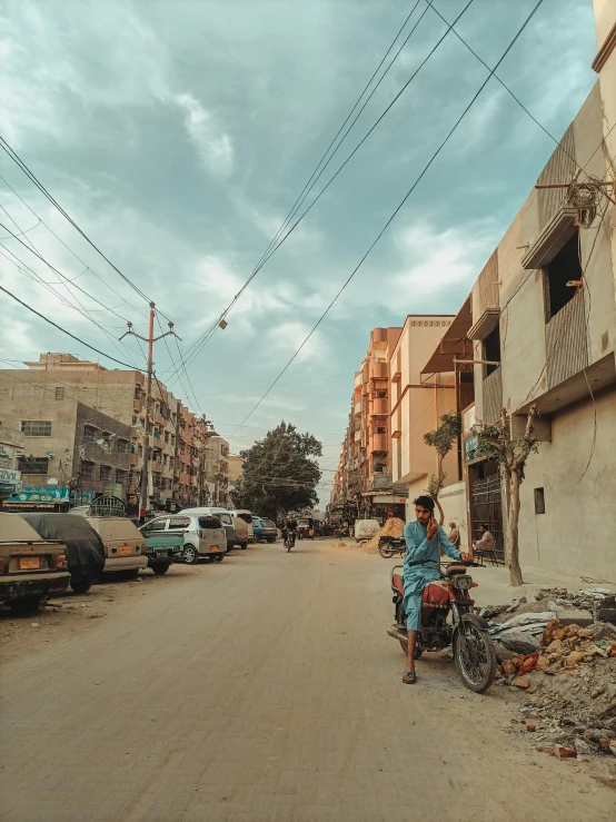 a woman riding a bike down a city street