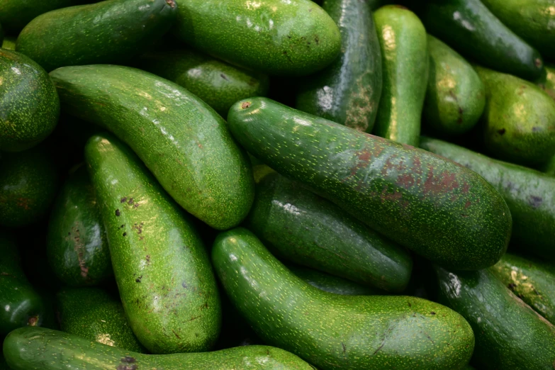 a pile of zucchini with green paint on them