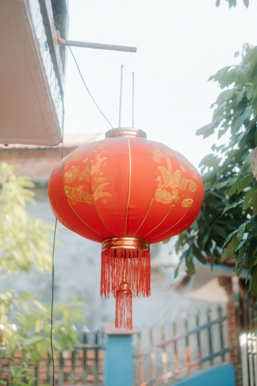 a lantern hanging from a wire near a building