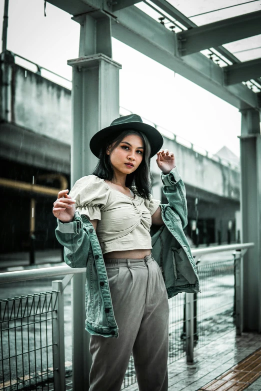 a woman posing in front of an over sized structure