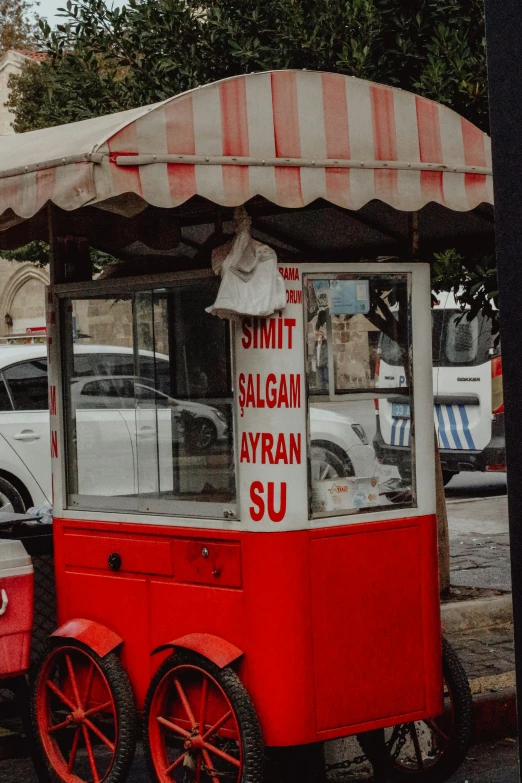 a little red cart that is sitting in the street