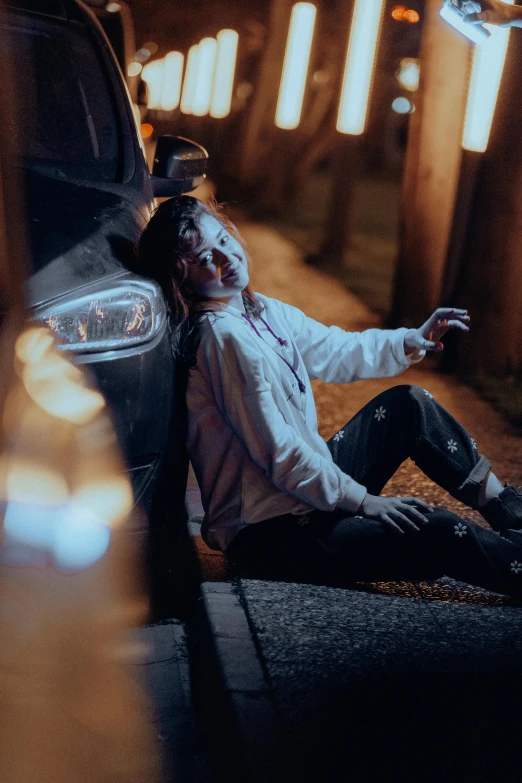 a woman with glasses is resting near a car