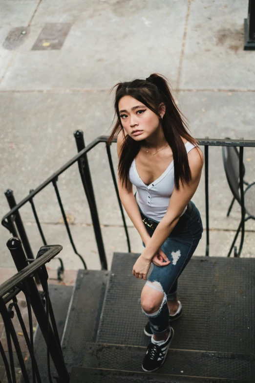 a woman standing at the top of a flight of steps