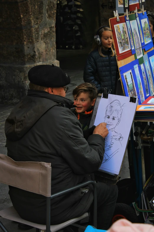 a man holds up his drawing for the child