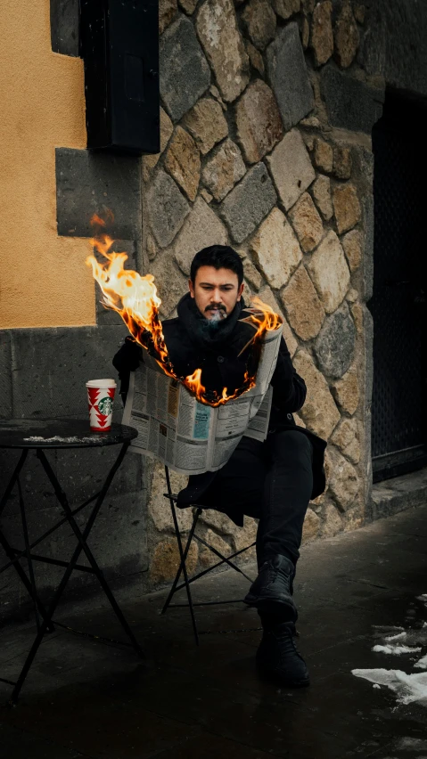 a man sitting in a chair on top of a sidewalk