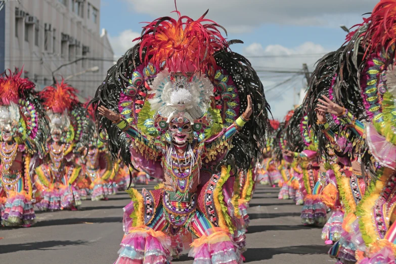 women in colorful costumes are in the street