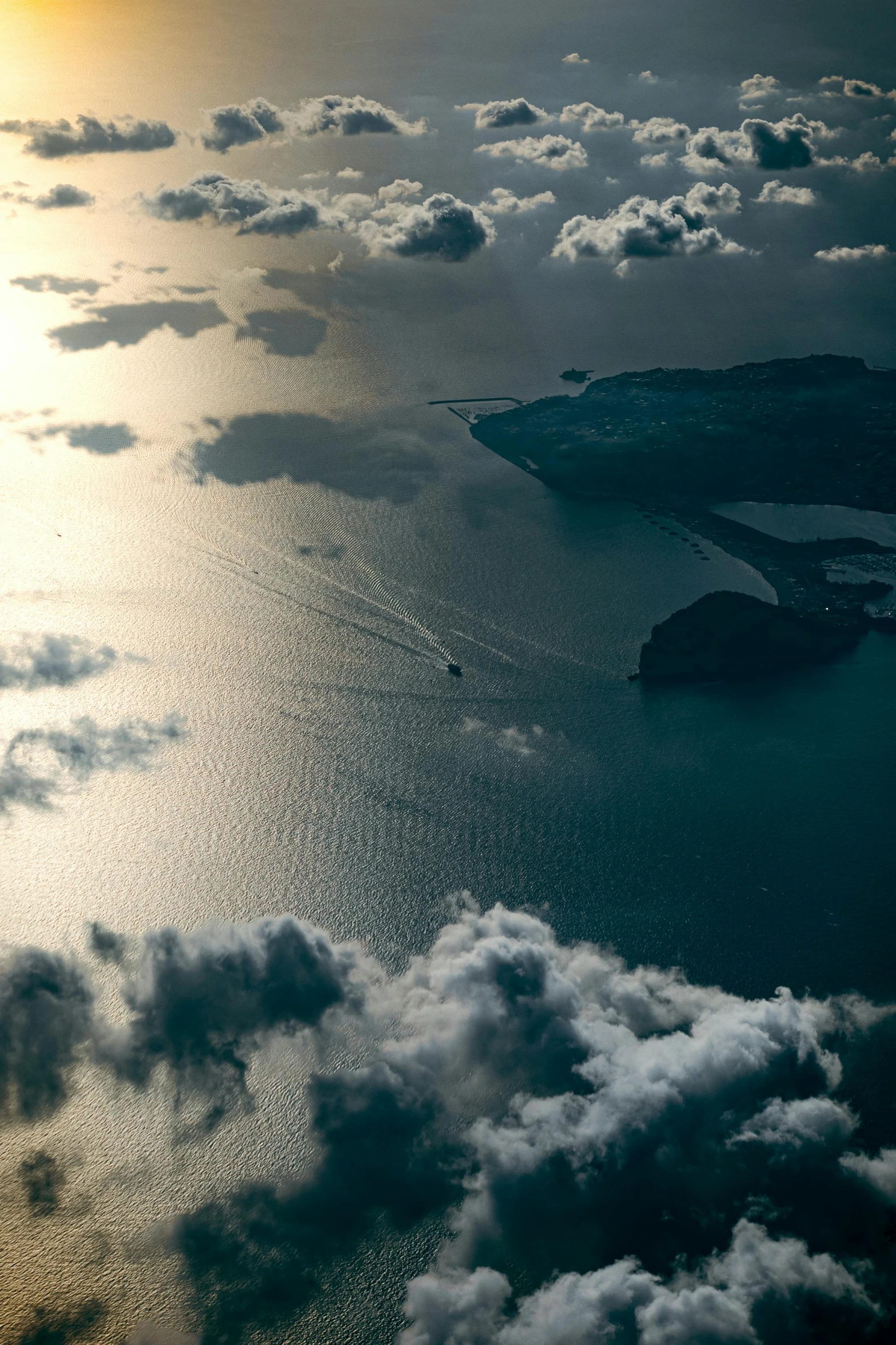 an aerial view of water with a city in the distance