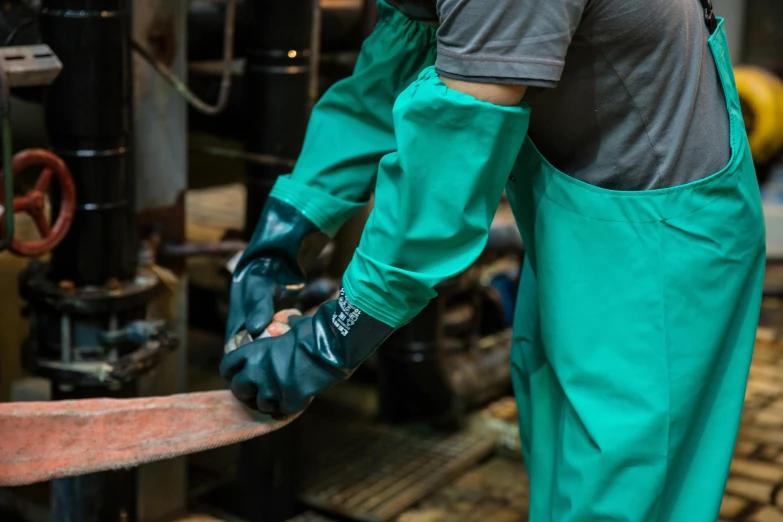 two men are working with a grinder and a hammer