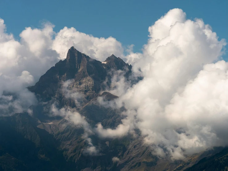 a po looking down the side of a mountain in the sky