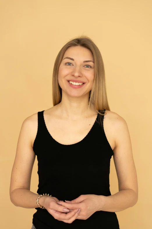 a woman in a tank top is posing for a picture