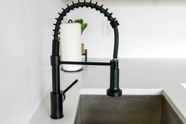 a black sink with some black handles