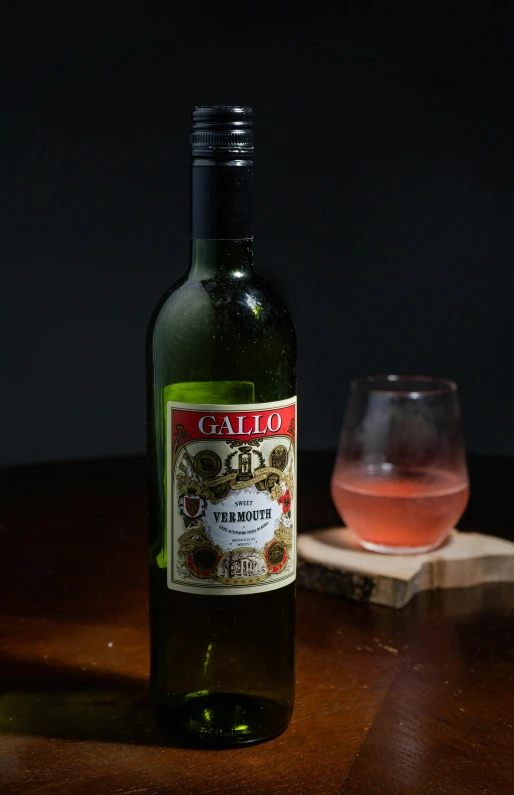 a wooden table with a bottle and a glass