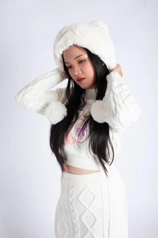 a young woman in a white sweater and skirt with a furry hoodie