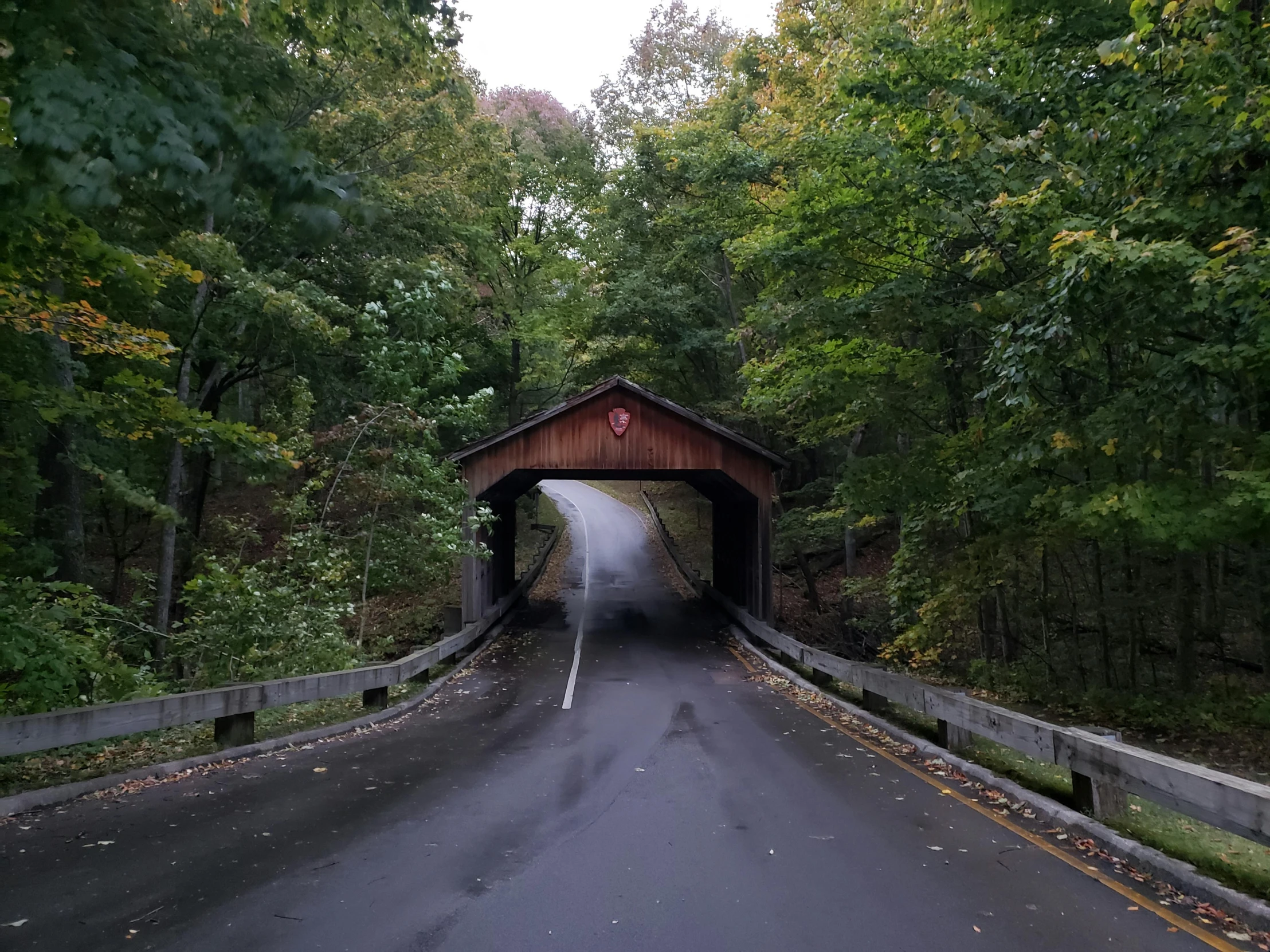 a covered bridge on a very narrow road