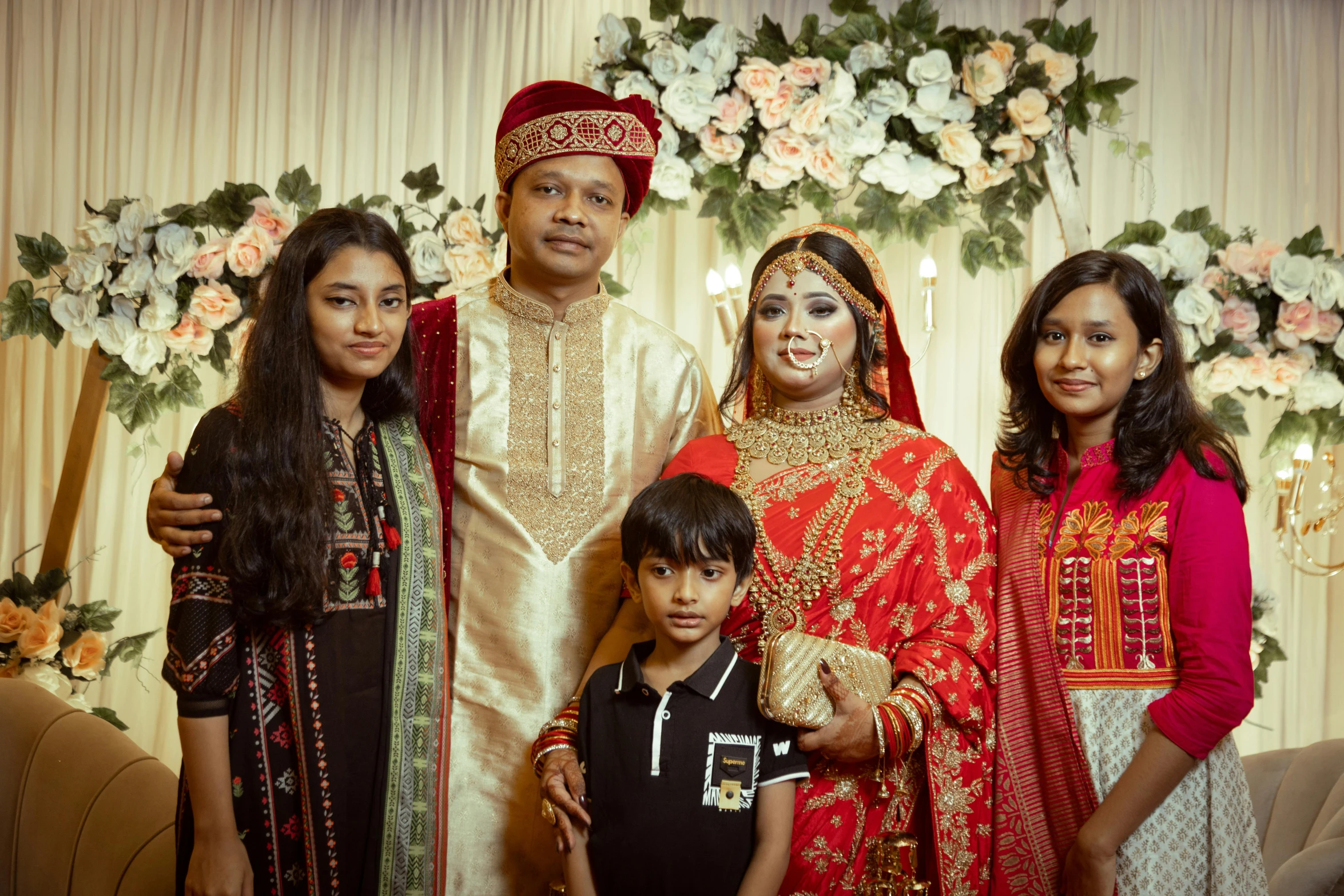 a couple and three children in traditional indian dress