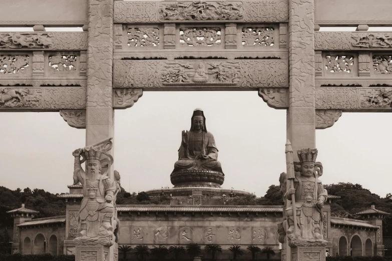 a statue on top of a building that has ornate carvings