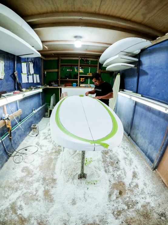 a surfboard sits in a vehicle that is being worked on