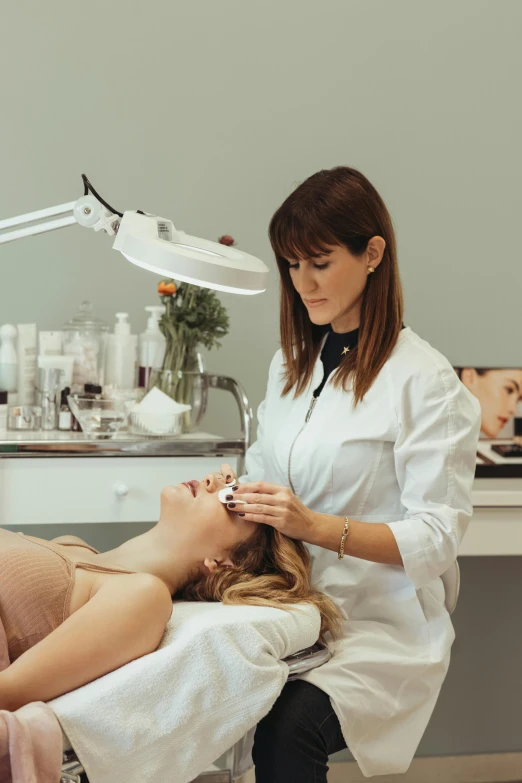 a woman sitting at a hairdresser talking to a lady