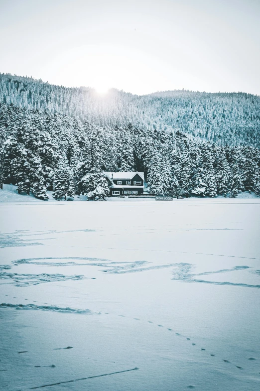 a view of the mountains and a snowy field