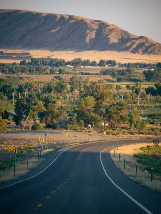 a road is pictured in front of the mountain range