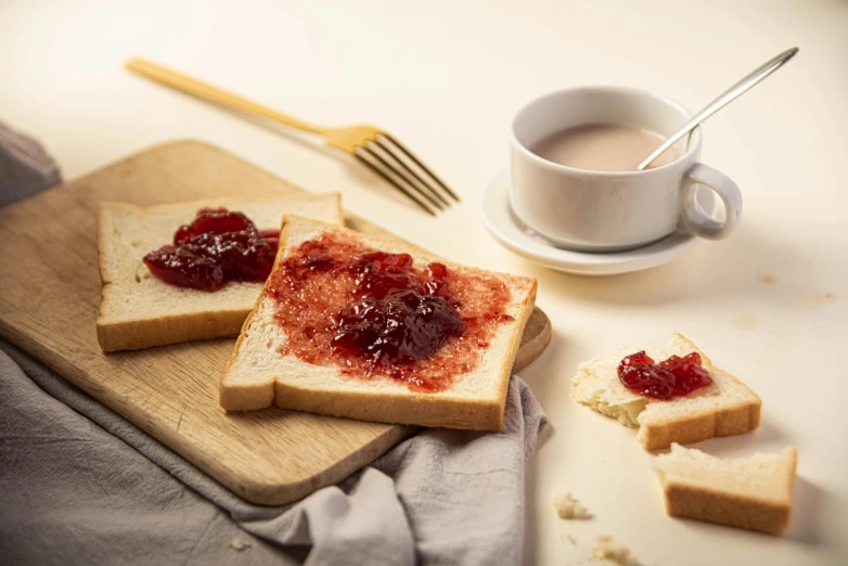 jam on a slice of bread sitting on a  board