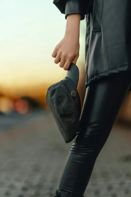 a person in black jacket and pants with hat