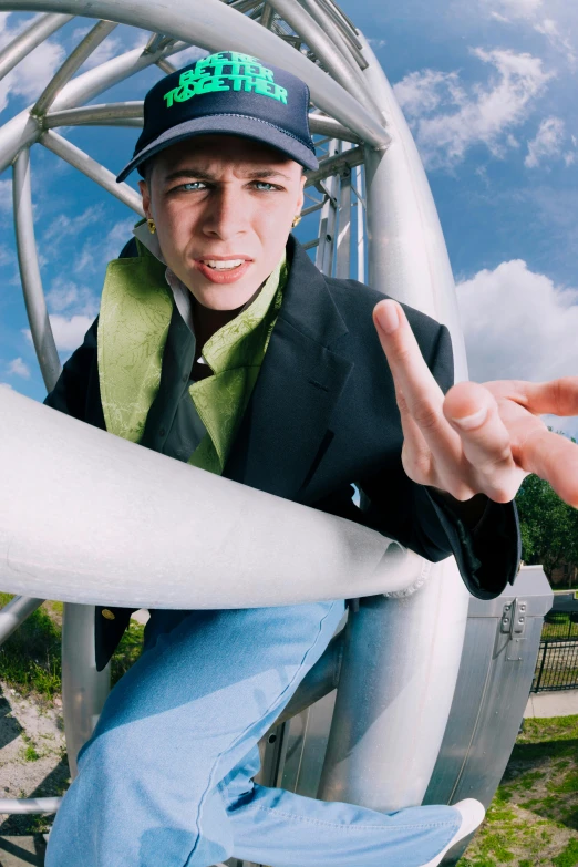 man holding a surf board and showing two fingers