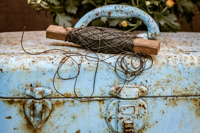 an old rusty piece of metal with cords hanging