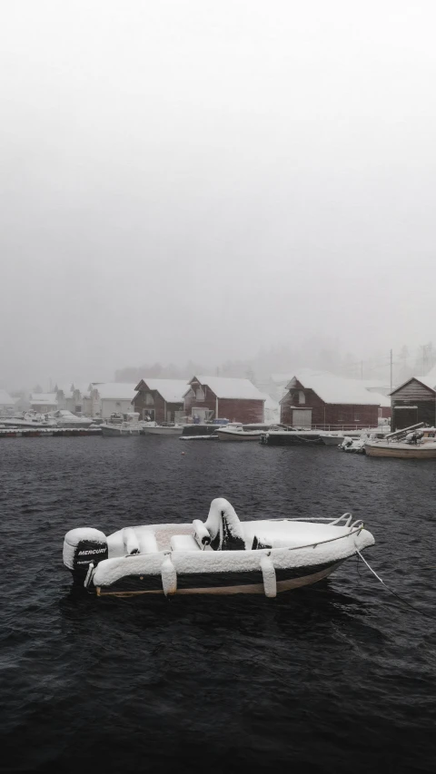 a small boat floating down a lake surrounded by houses