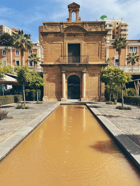 an old palace building sitting next to water