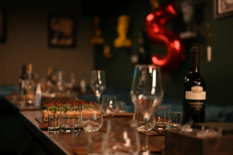 a wine bar with glasses and bottles on it