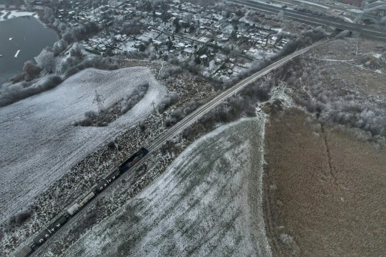 an aerial view of some snow covered streets and a body of water