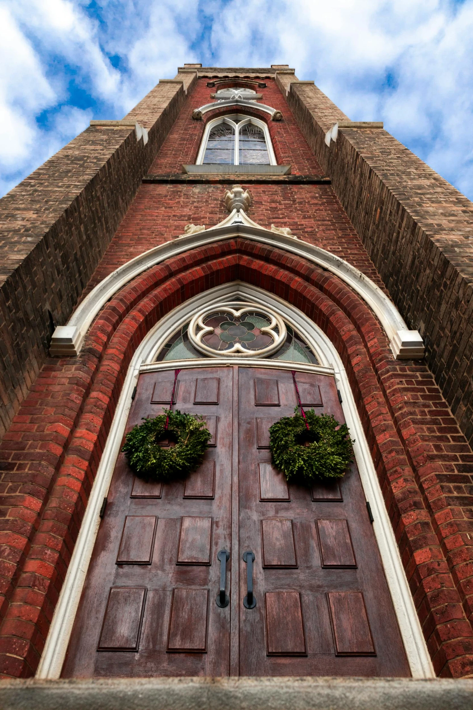 the window above the door is decorated with two wreaths